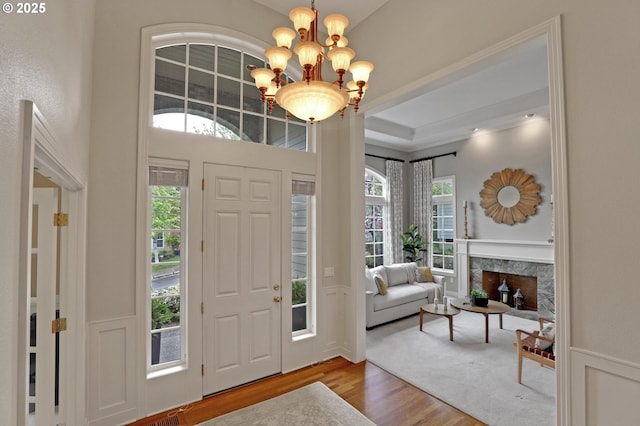 foyer with wood finished floors and a chandelier