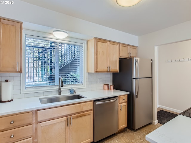 kitchen featuring a sink, light countertops, light brown cabinetry, and stainless steel appliances