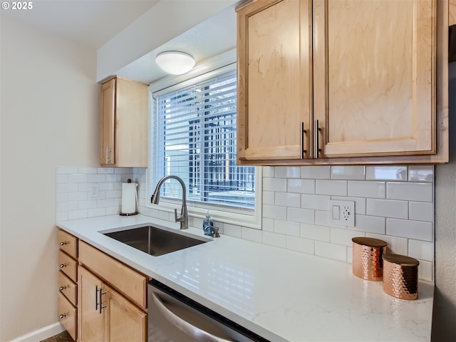 kitchen featuring dishwasher, tasteful backsplash, light brown cabinetry, and a sink