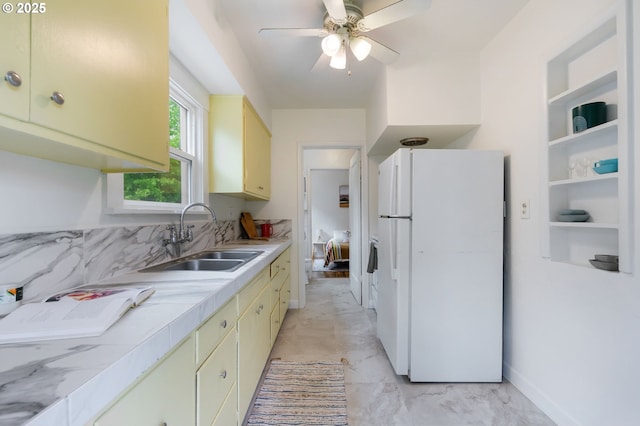 3905 SE 54th Ave, Portland, OR 97206 - kitchen featuring freestanding refrigerator, light countertops, a sink, cream cabinets, and a ceiling fan