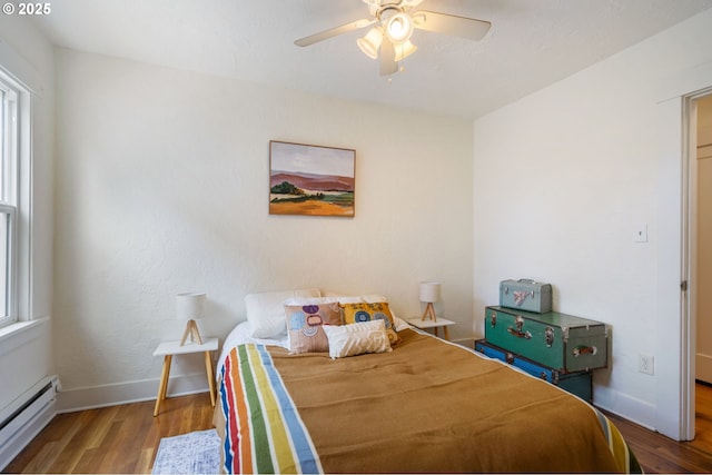 3905 SE 54th Ave, Portland, OR 97206 - bedroom featuring a baseboard radiator, wood finished floors, baseboards, and ceiling fan