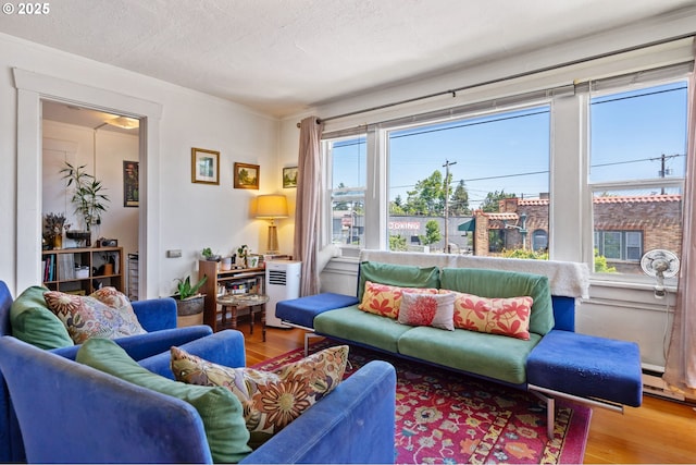 3905 SE 54th Ave, Portland, OR 97206 - living area with wood finished floors, a textured ceiling, and crown molding