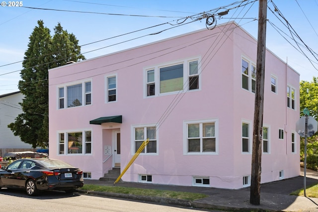 3905 SE 54th Ave, Portland, OR 97206 - townhome / multi-family property featuring entry steps and stucco siding
