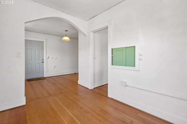 3905 SE 54th Ave, Portland, OR 97206 - spare room featuring arched walkways, wood-type flooring, and baseboards