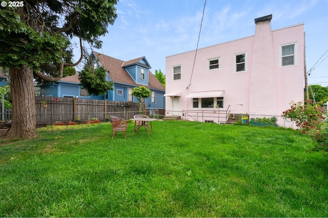 3905 SE 54th Ave, Portland, OR 97206 - rear view of house with stucco siding and a chimney