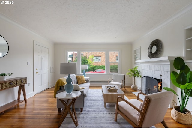 3905 SE 54th Ave, Portland, OR 97206 - living area with wood finished floors, a fireplace, a textured ceiling, crown molding, and built in shelves