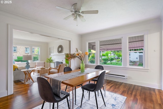 3905 SE 54th Ave, Portland, OR 97206 - dining area with a baseboard radiator, ornamental molding, wood finished floors, ceiling fan, and baseboards