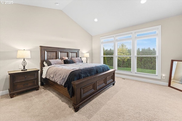 bedroom with light colored carpet and lofted ceiling