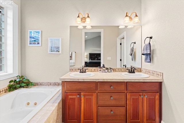 bathroom with vanity and tiled bath