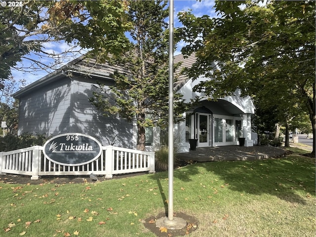 view of property exterior with a lawn