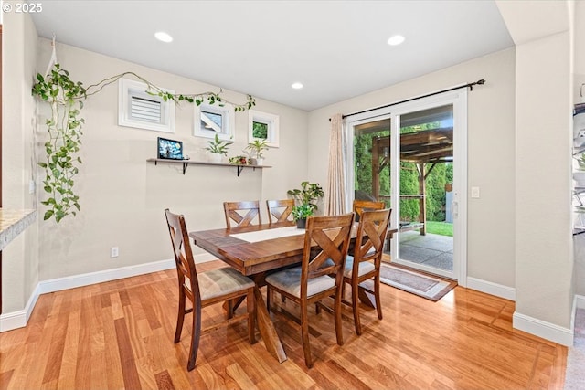 dining space featuring light wood-type flooring and plenty of natural light