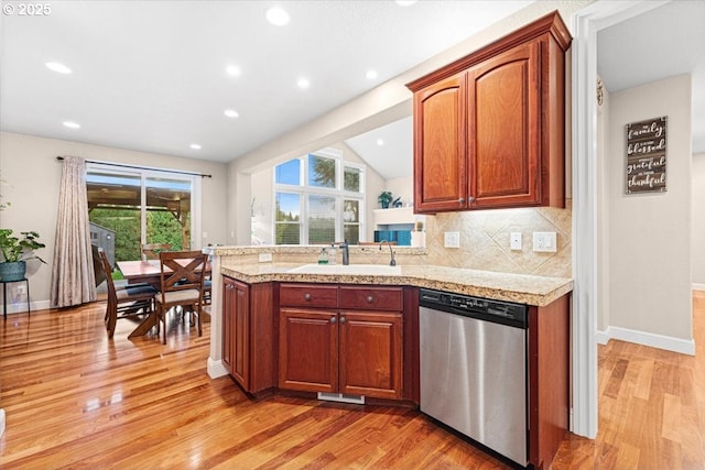 kitchen with dishwasher, light wood-type flooring, backsplash, and sink