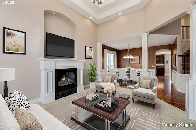 living room featuring a towering ceiling and a chandelier