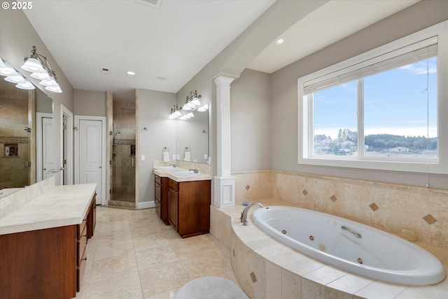 bathroom with tile patterned floors, vanity, ornate columns, and separate shower and tub