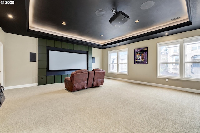 home theater room with carpet flooring and a tray ceiling