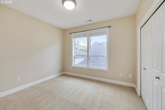 unfurnished bedroom with carpet floors and a closet