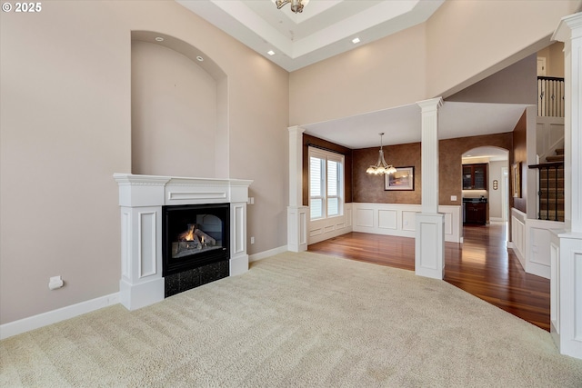 unfurnished living room with light colored carpet and a notable chandelier