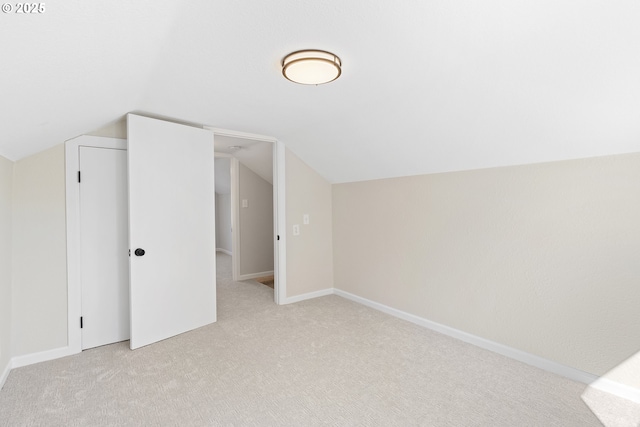 bonus room featuring light carpet, vaulted ceiling, and baseboards