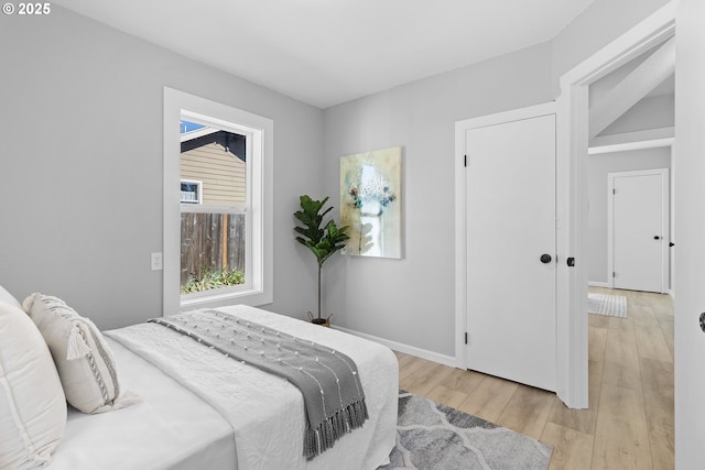 bedroom featuring light wood-style flooring and baseboards