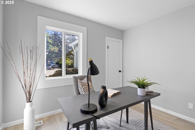 office area featuring light wood-style floors and baseboards