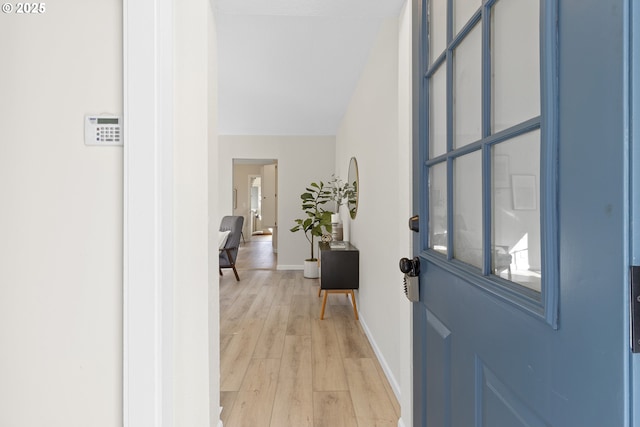 foyer featuring baseboards and light wood finished floors