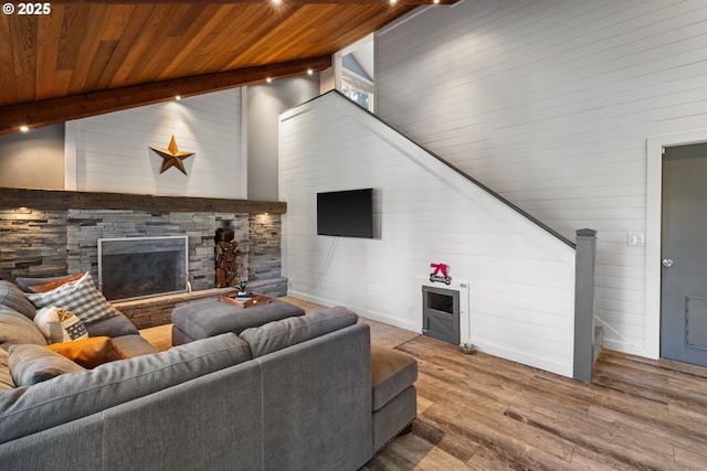 27650 SW Canyon Creek Rd, Wilsonville, OR 97070 - living room featuring high vaulted ceiling, a stone fireplace, wood finished floors, wooden walls, and wooden ceiling with exposed beams