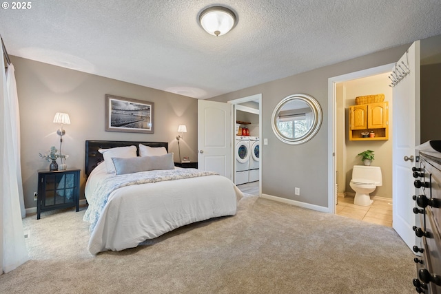 27650 SW Canyon Creek Rd, Wilsonville, OR 97070 - bedroom with separate washer and dryer, light colored carpet, a textured ceiling, baseboards, and ensuite bath