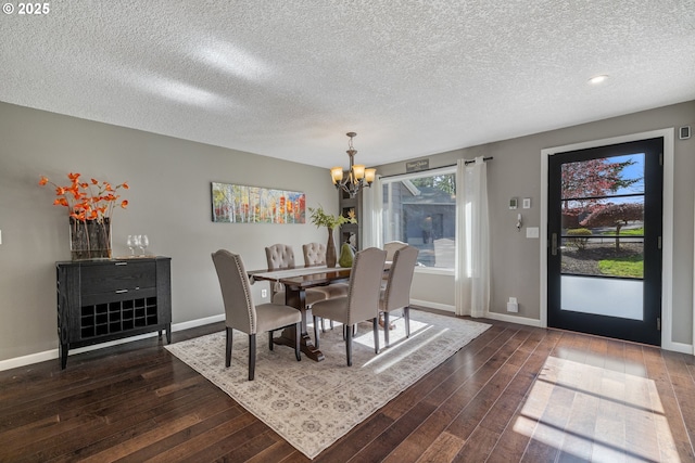 27650 SW Canyon Creek Rd, Wilsonville, OR 97070 - dining area with a chandelier, dark wood finished floors, a textured ceiling, and baseboards