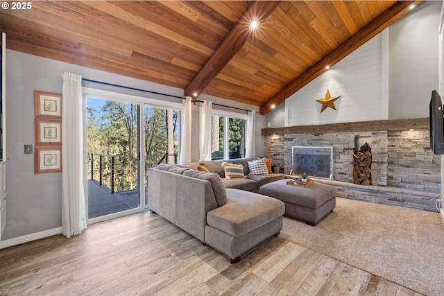 27650 SW Canyon Creek Rd, Wilsonville, OR 97070 - living area featuring light wood finished floors, wooden ceiling with exposed beams, a stone fireplace, baseboards, and high vaulted ceiling
