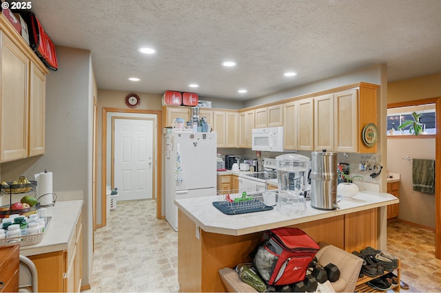 kitchen with light brown cabinetry, white appliances, kitchen peninsula, and a breakfast bar