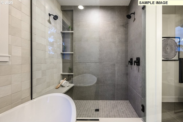 bathroom with tile patterned floors and separate shower and tub