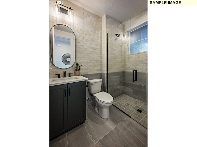 bathroom featuring vanity, decorative backsplash, a shower with door, and a textured ceiling