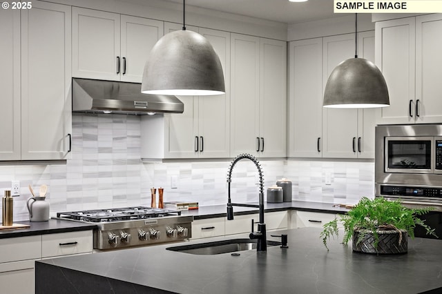 kitchen featuring sink, hanging light fixtures, stainless steel appliances, decorative backsplash, and exhaust hood