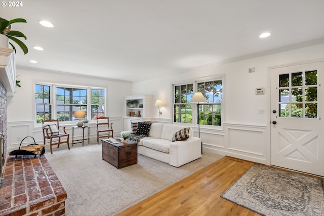 living room with a fireplace and ornamental molding