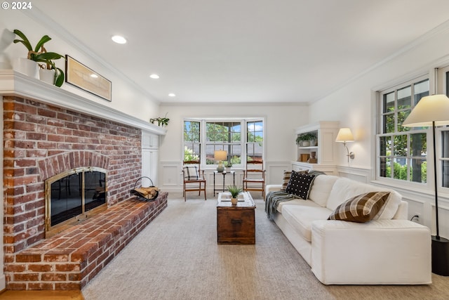 carpeted living room with crown molding and a fireplace