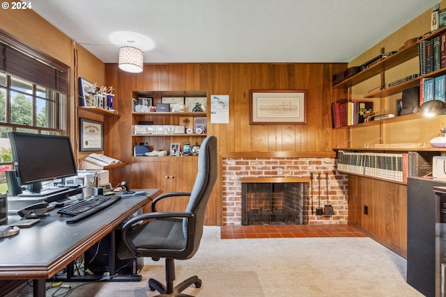 office space with light colored carpet, wood walls, and a fireplace