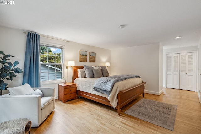 bedroom with a closet and light hardwood / wood-style flooring