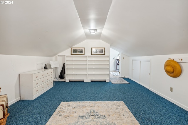 bonus room featuring vaulted ceiling and dark colored carpet