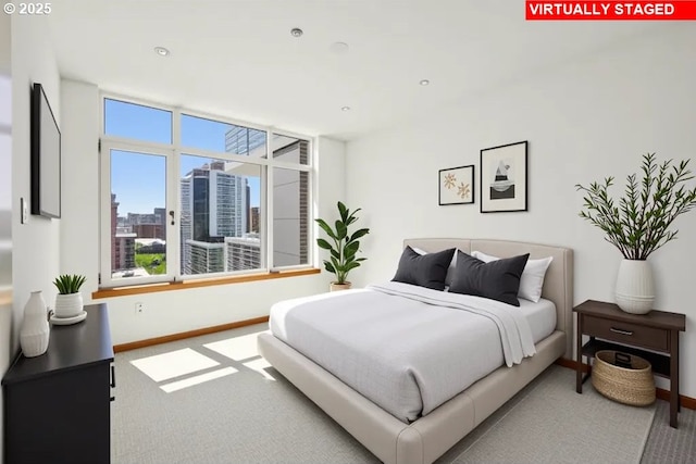carpeted bedroom with baseboards and a view of city