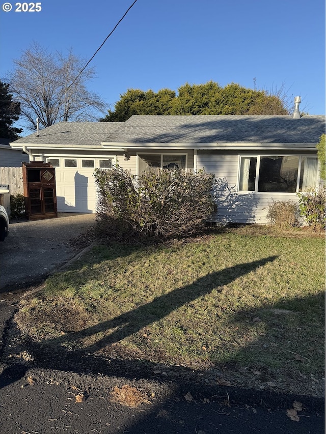 view of home's exterior featuring a garage, a yard, and driveway