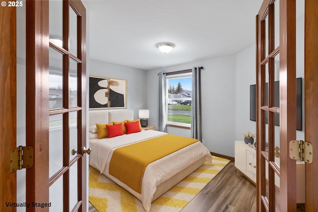 2744 Dayna Ln, Eugene, OR 97408 - bedroom featuring french doors, wood finished floors, and baseboards