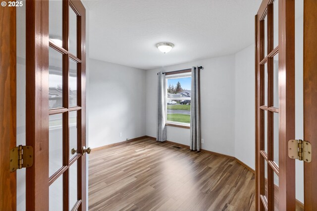 2744 Dayna Ln, Eugene, OR 97408 - spare room featuring french doors and wood finished floors