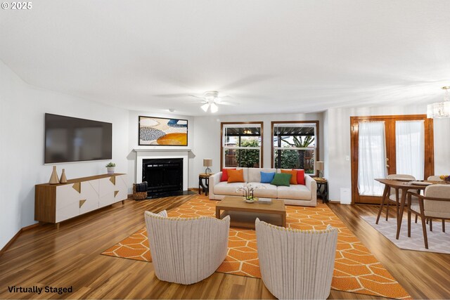 2744 Dayna Ln, Eugene, OR 97408 - living area with a ceiling fan, wood finished floors, a fireplace, and a chandelier