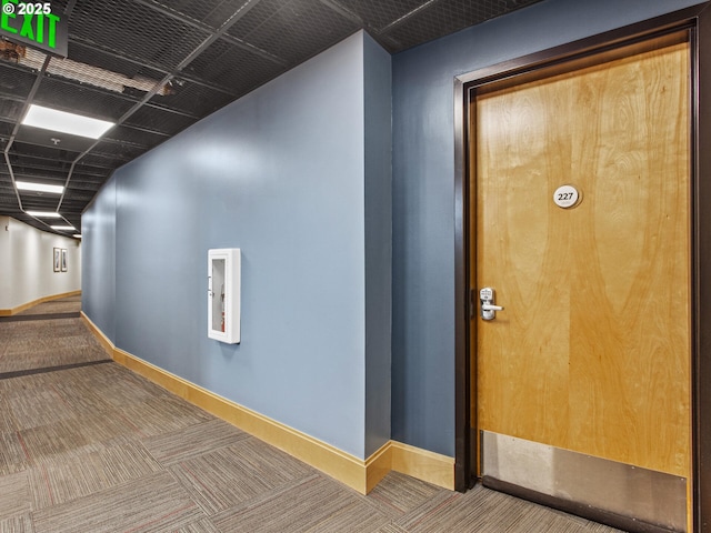 corridor with carpet flooring