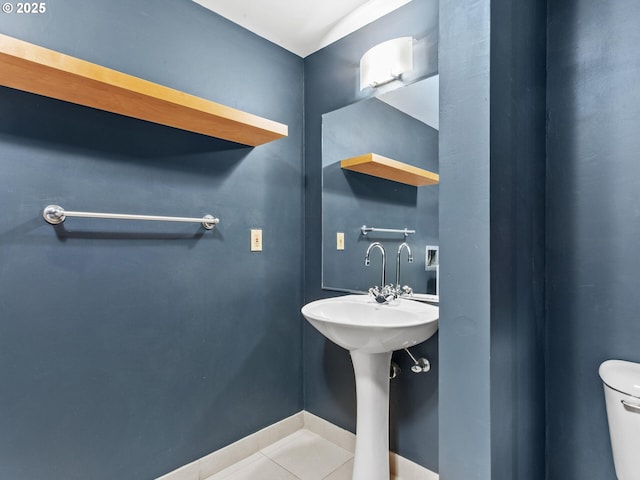 bathroom with tile patterned flooring and toilet