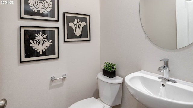 half bath with a sink and toilet