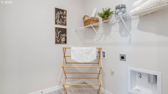 clothes washing area with laundry area, hookup for a washing machine, baseboards, and hookup for an electric dryer
