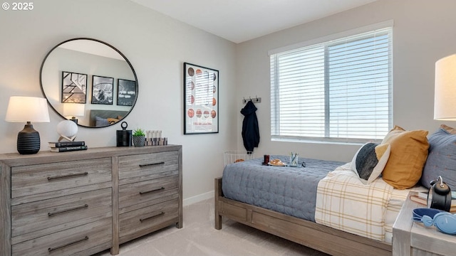 bedroom with baseboards, multiple windows, and light carpet