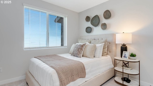 bedroom featuring baseboards and multiple windows