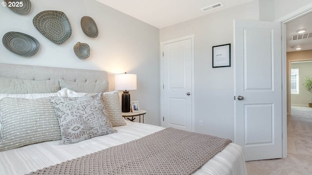 carpeted bedroom with visible vents and lofted ceiling
